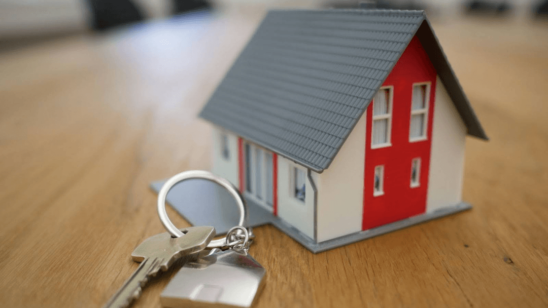 Miniature figure of a house with house keys on a table. The owners have read Texas Tax Protest blogs and are ready to protest their property taxes.