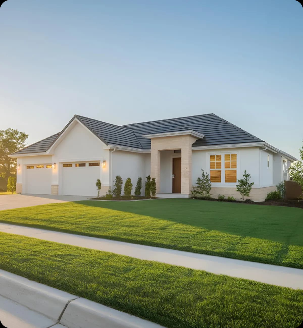 Single-story Texas home with a white stucco exterior, tile roof, and manicured front lawn at sunset.