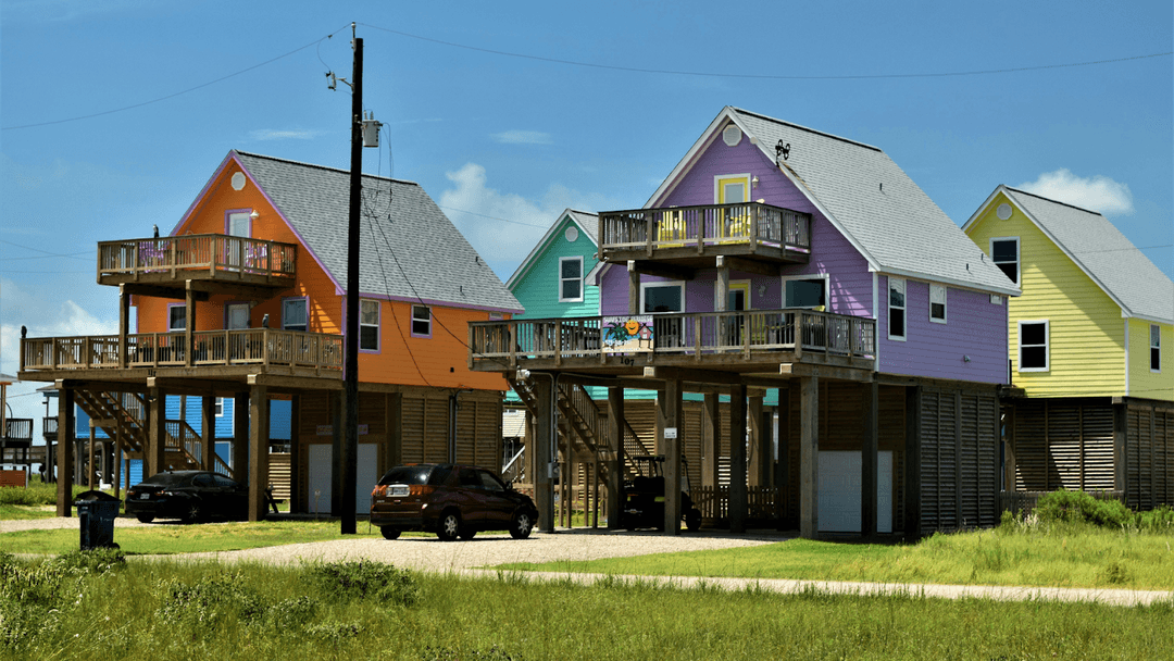A row of colorful coastal homes in Surfside Beach, Texas.