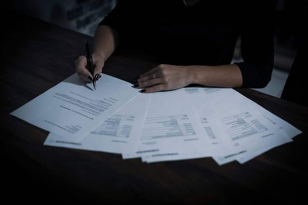 Person Filling Out Paperwork For Valuation Date