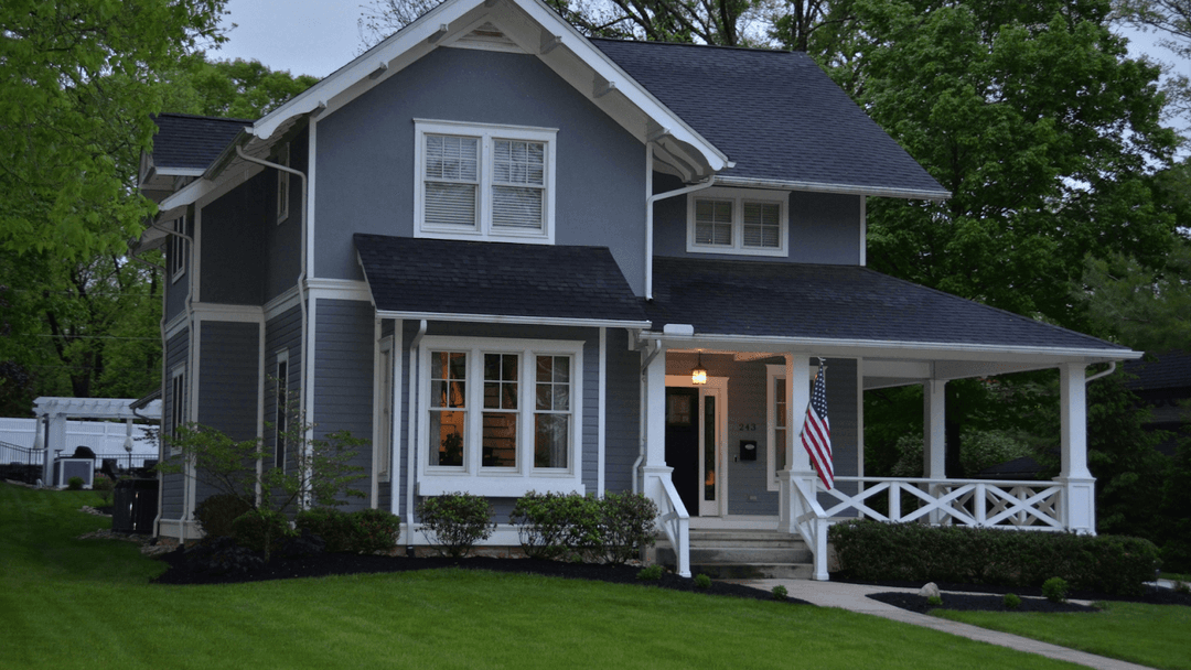 Historic 2-story gray house with white trimming
