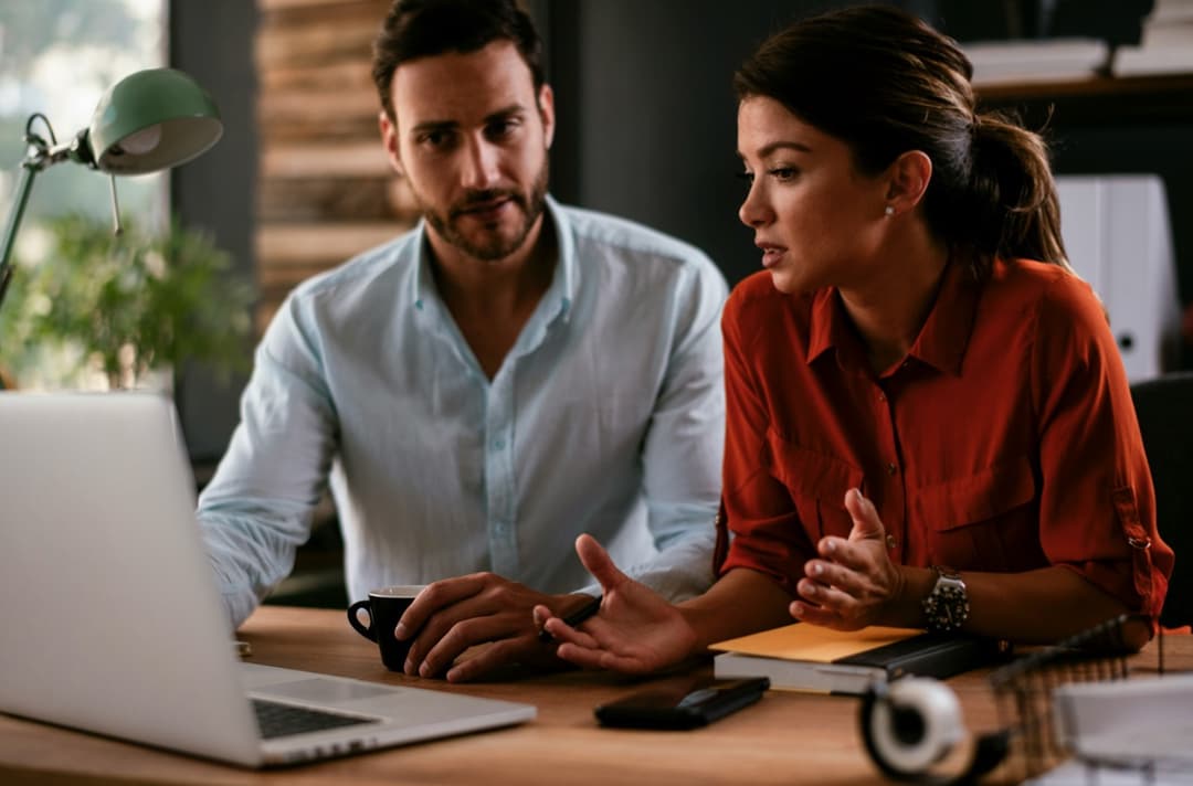 Man and woman reading the Texas Tax Protest article "How to Estimate Your Texas Property Taxes Before They Arrive"