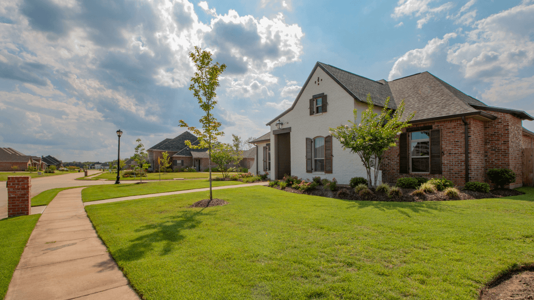 White And Red Brick Home With Newly Planted Landscaping