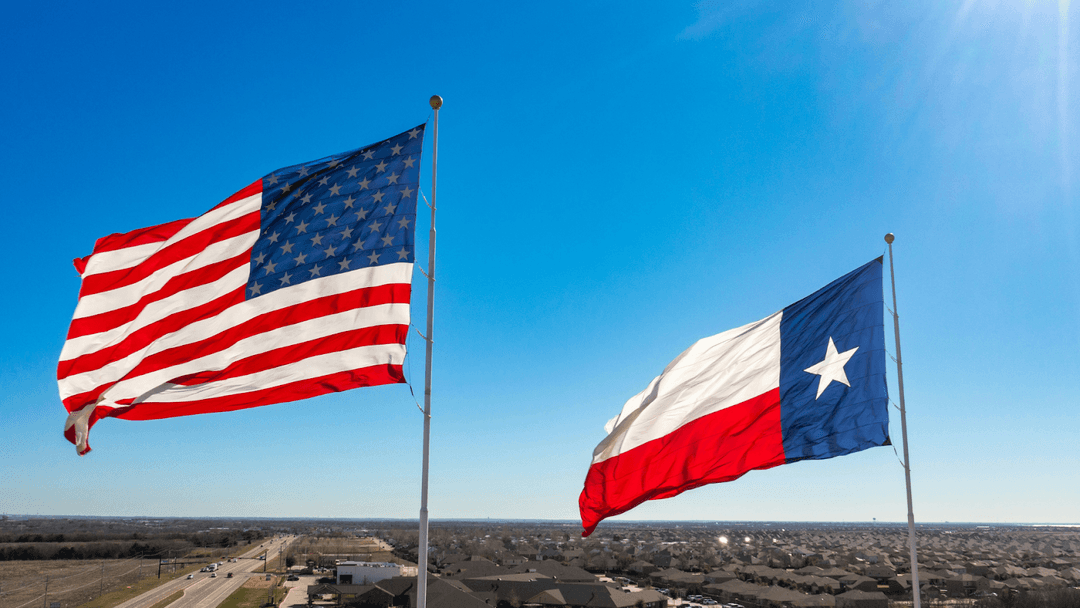 American and Texas state flags swaying in the wind