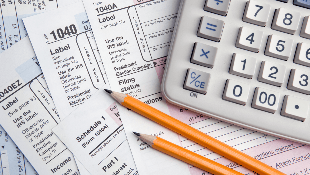 Tax forms, calculator, and pencils used to calculate property tax assessments and adjustments
