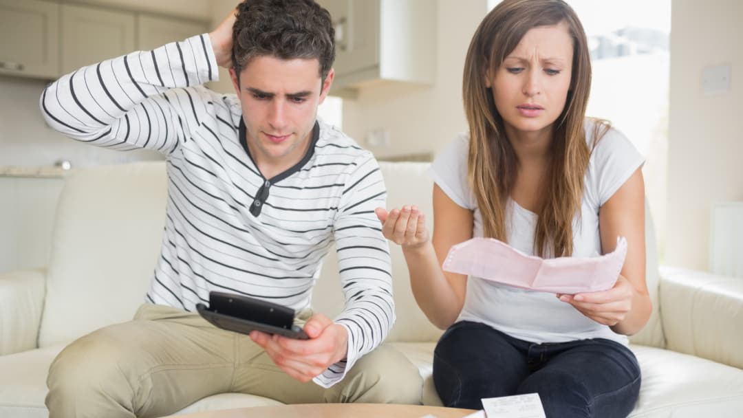 Worried couple reviewing a Texas property tax bill with penalty and interest